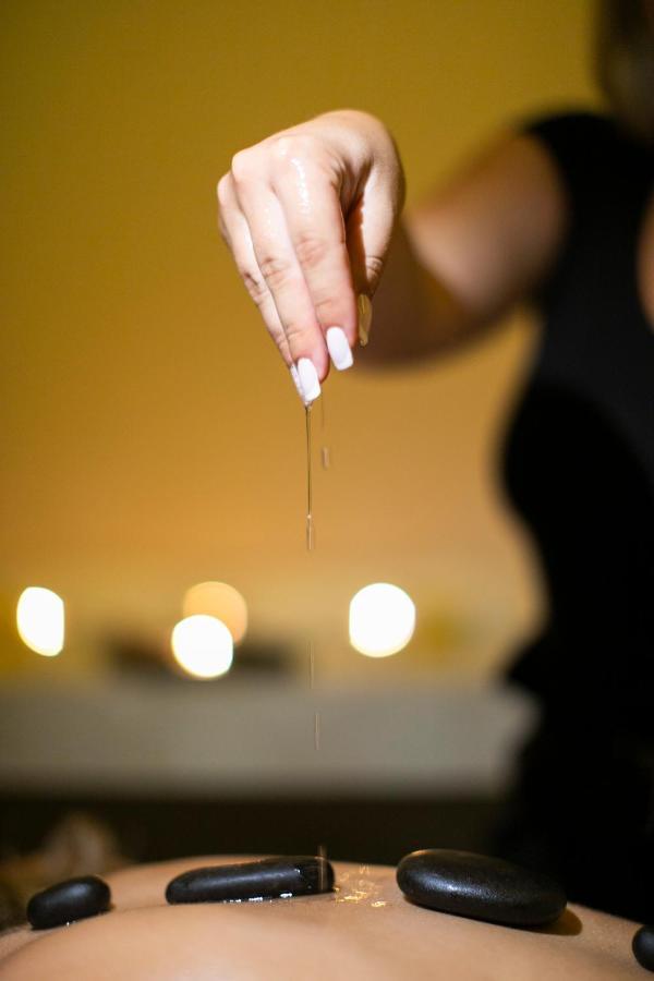 Alia Palace Hotel - Adults Only 16+ Chalkidiki Exterior photo A woman dripping oil on her hands