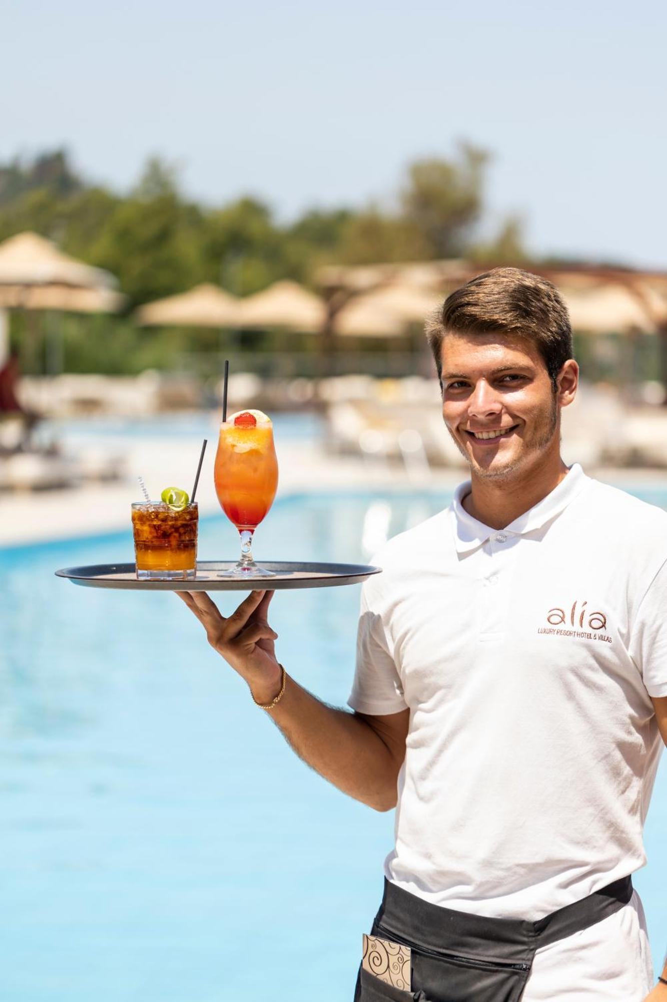 Alia Palace Hotel - Adults Only 16+ Chalkidiki Exterior photo A waiter serving drinks